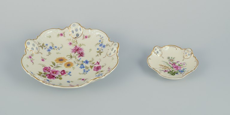 Rosenthal, Germany. Two "Moliere" porcelain bowls with reticulated rim. 
Decorated with polychrome flowers on a cream-colored background. Gold rim.