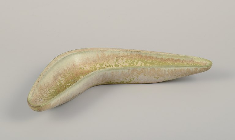 Gunnar Nylund for Rörstrand. Boomerang-shaped ceramic bowl.
Eggshell glaze in light green and sand-colored tones.