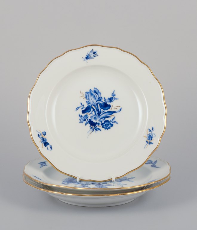 Meissen, Germany. Three hand-painted porcelain plates with blue flowers and 
insects, gold rim.