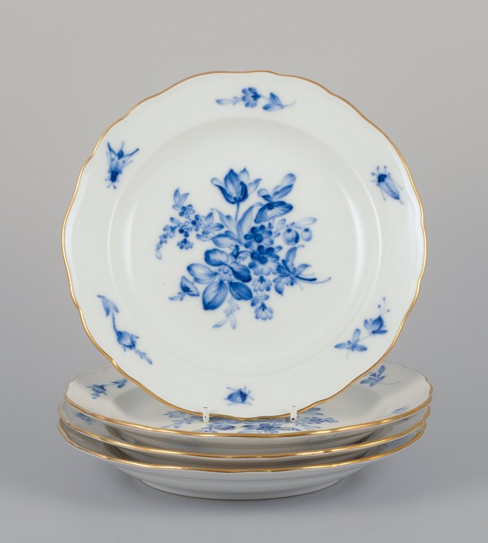 Meissen, Germany. A set of four antique porcelain plates hand-painted with blue 
flowers and insects, gold rim.