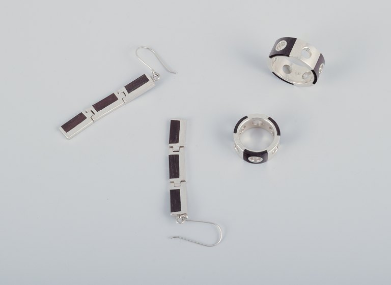 Swedish jewelry artist. Two rings and a pair of earrings in sterling silver and 
dark wood.