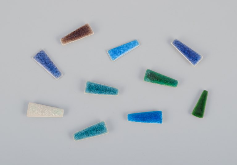 Ole Bjørn Krüger (1922-2007), Danish sculptor and ceramicist.
Ten unique brooches in glazed stoneware in blue, white, purple, brown, and 
green hues.