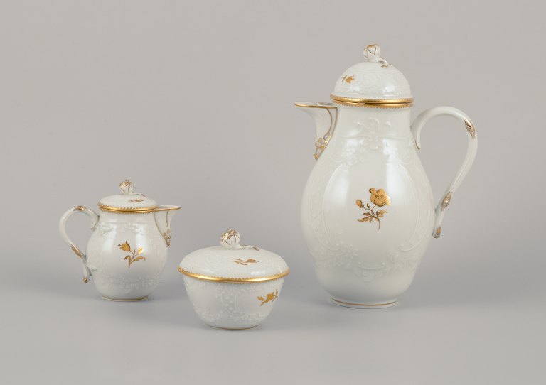 Meissen, Germany. 
Porcelain coffee set comprising a coffee pot, creamer, and sugar bow