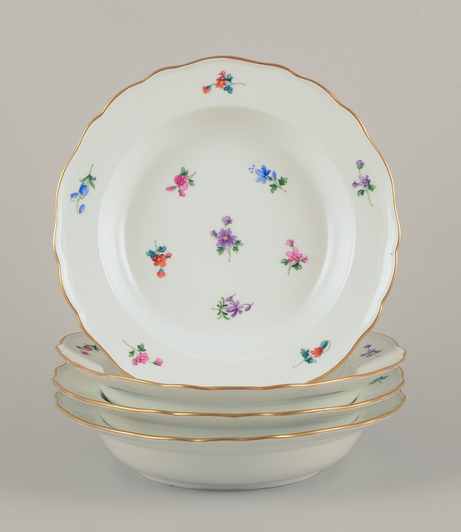 Meissen, Germany. Four large deep porcelain plates.
Hand-painted with polychrome floral motifs.