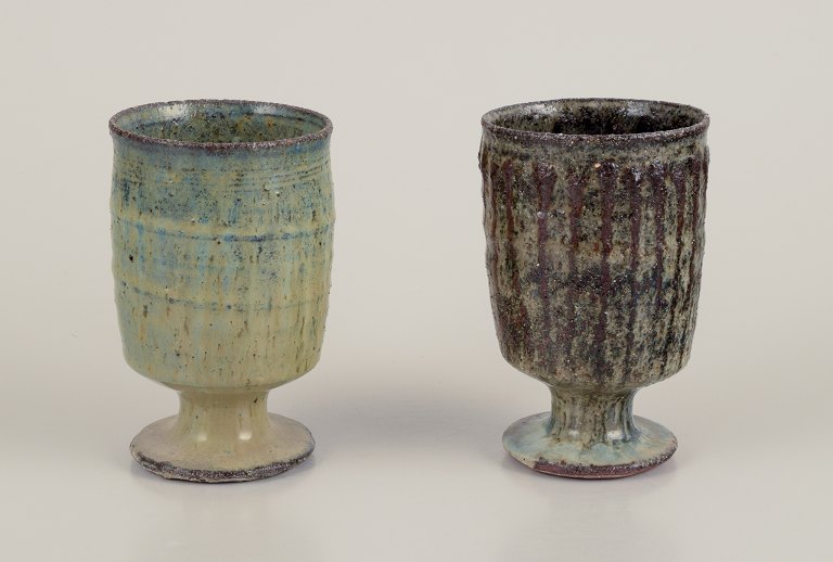 Gutte Eriksen, Denmark.
Two cups in ceramic, raku technique, flowing lava glaze in brown tones.