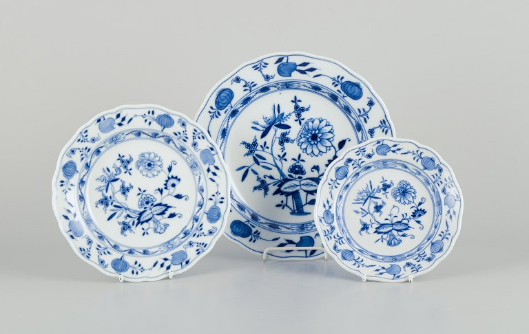 Meissen Blue Onion pattern. Three plates. Hand-painted with blue floral motifs.
