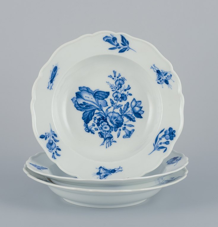 Meissen, Germany, three large deep plates.
Hand-decorated with flowers and insects in blue.