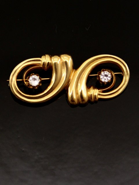 14 carat gold brooch with 2 zircons