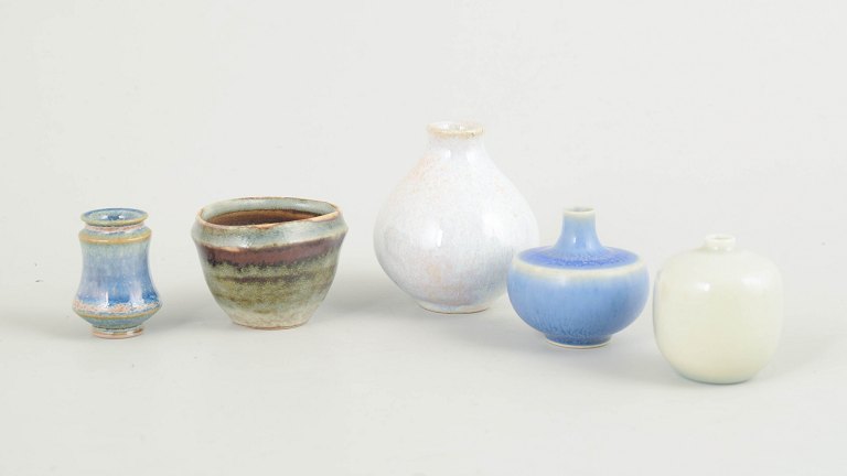 Set of five miniature ceramic bowls and vases.