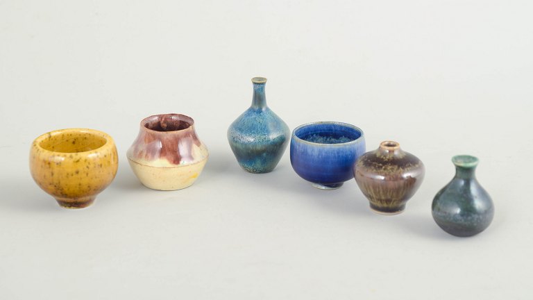 Set of six miniature ceramic bowls and vases.