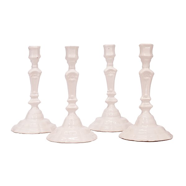 Set of four light glazed Rococo faience candlesticks.Made circa 1760.Height: 23cm. Diameter of base: 13cm